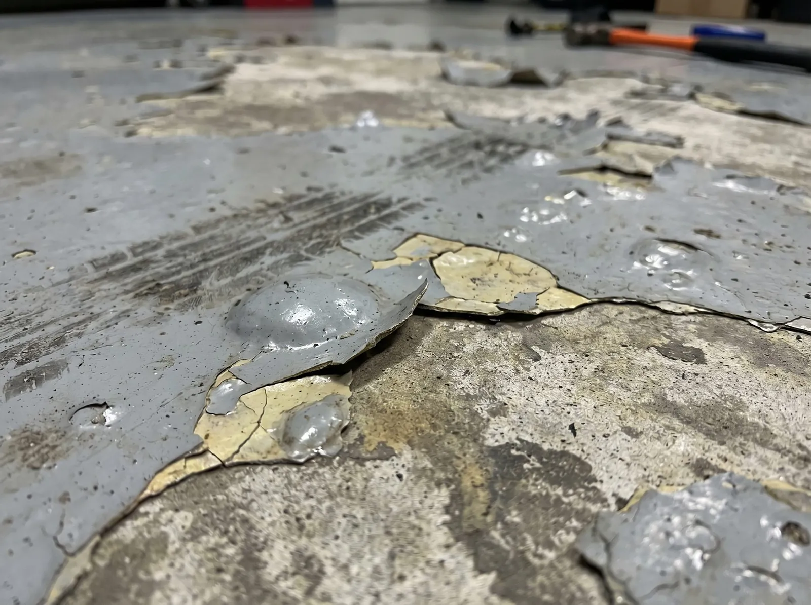 Failing DIY epoxy kit peeling off concrete